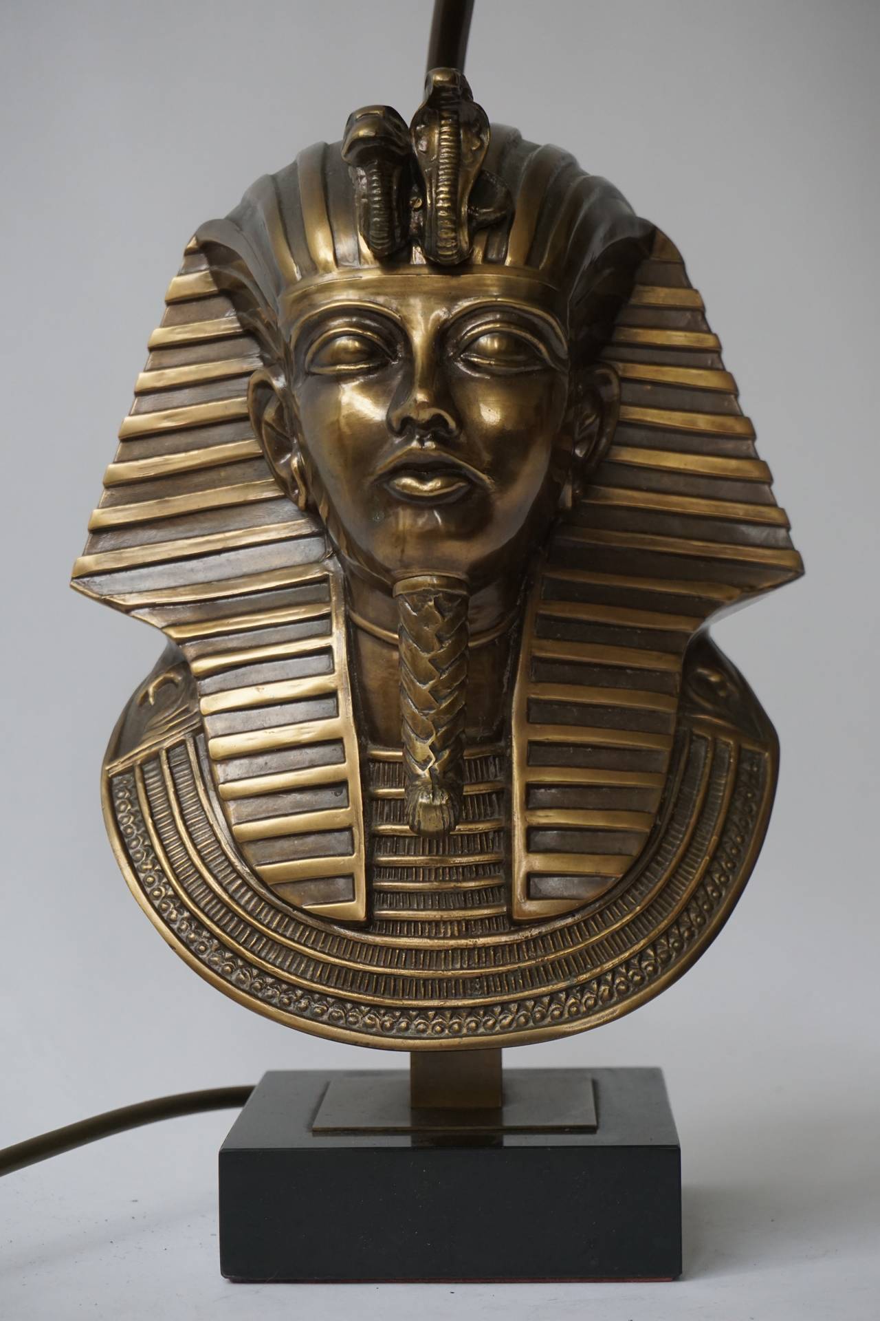 A Egyptian revival pharaoh head table lamp in brass/bronze 24-karat gold-plated on black marble base.
Price without shade.
