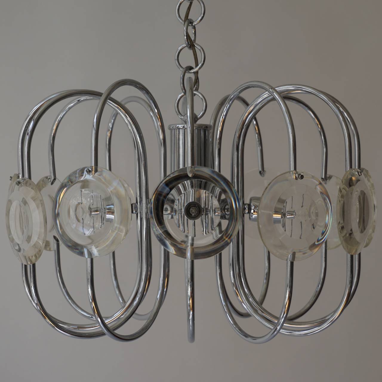 Italian chandelier in glass by Gaetano Sciolari.

Ceiling lamp designed by Gaetano Sciolari in the 1960s, made of tubular chromed steel and glass with four light points.