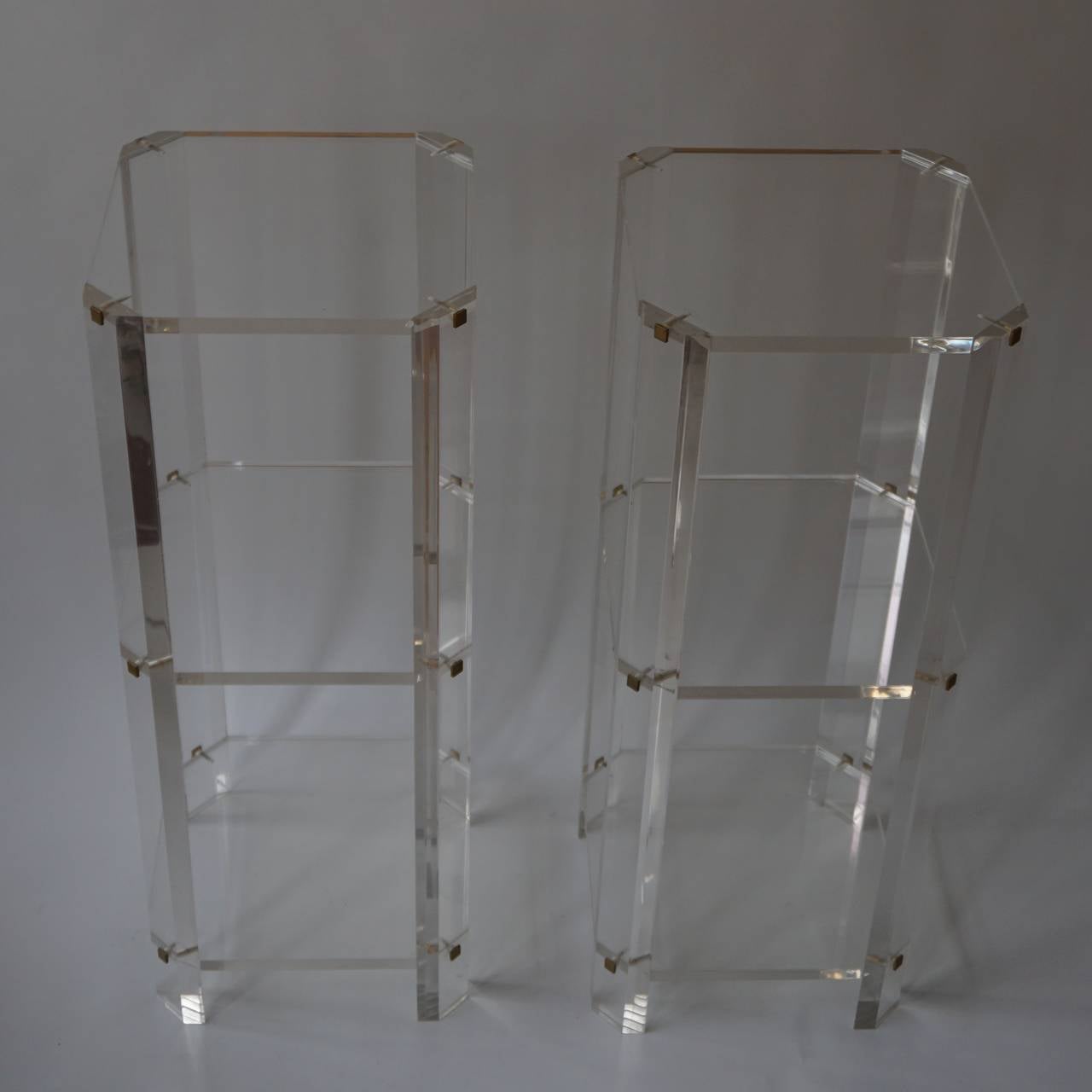 Two Lucite etageres.