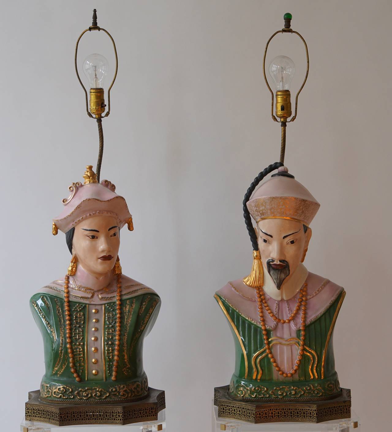 A pair of Italian decorative figures, representing a chinaman and woman on a canted and open worked iron stand.
Adapted as lamps and for electricity. 
First half 20th century.
Dimensions: Total height: 88 cm.