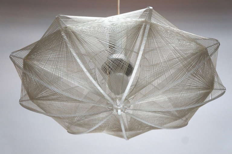 
Hanging light fixture has a chromed central support with clear Lucite wings that support an intricate white string form, circa 1970s. We have another similar fixture with a more angular / geometric shape. Please inquire.