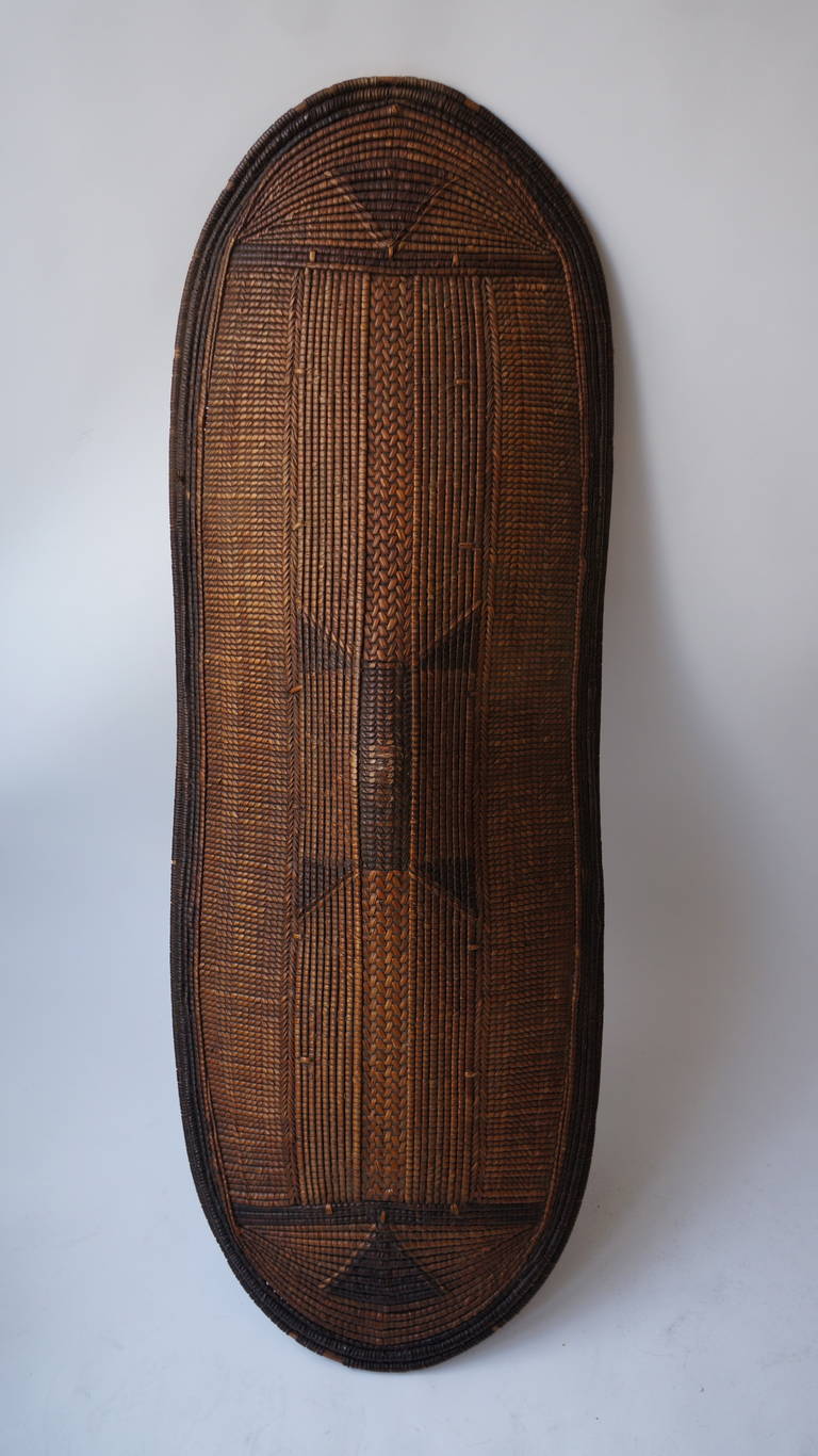 This beautiful Congo shield is a splendid example of a Classic woven type. Cleverly constructed to allow both substantial defense and swift mobility to its bearer on the battlefield, this piece was also conceived with a fabulous sense of aesthetics.