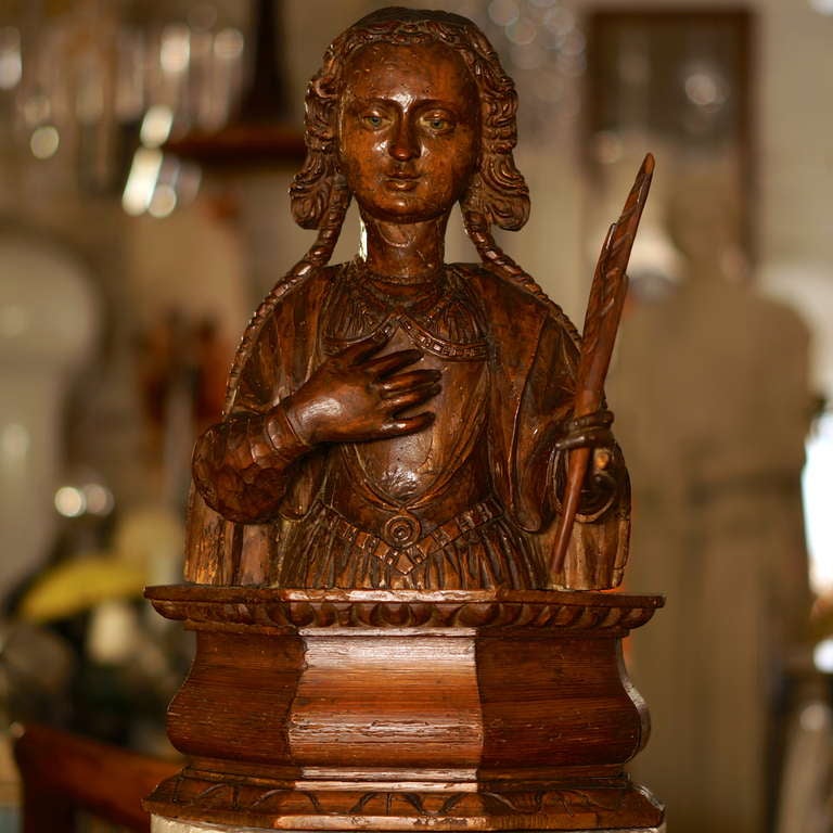 A lively 16th century walnut Italian renaissance sculpture of a female saint, holding a palm branch as a symbol for martyrdom, mounted on an 18th century pinewood support.
The inlaid glass eyes may point to a Neapolitan origin.