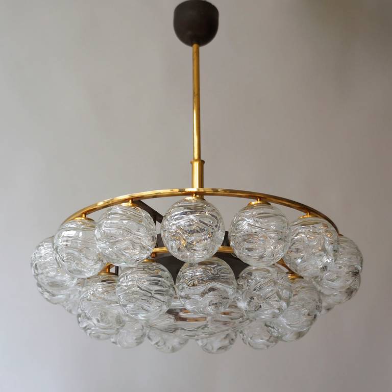 A vintage Doria flush mount fixture with clear glass balls supported by a brass base.