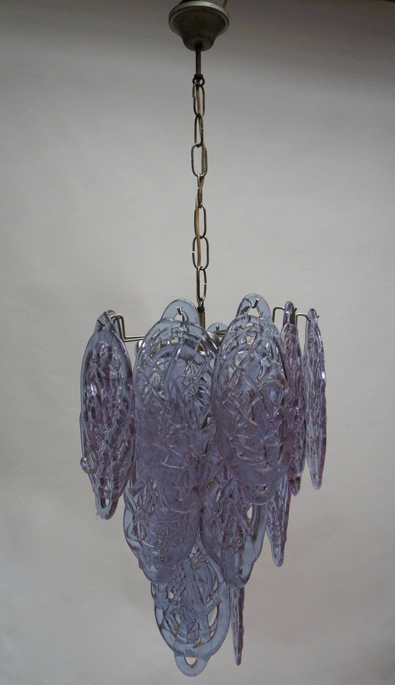 Wonderful vintage chandelier by Mazzega with purple glass pieces in a cascading motif. The glass is made to look like spun sugar and gives a great effect when lit.