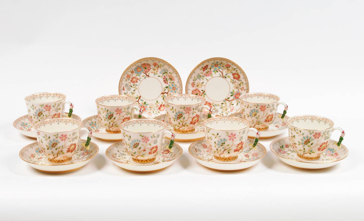 This set of eight teacups and saucers has a delicate, all-over raised floral decoration and features amusing tea masters on the handles of their finely cast form. Beautifully executed, this delightful set is in excellent condition and comes with two