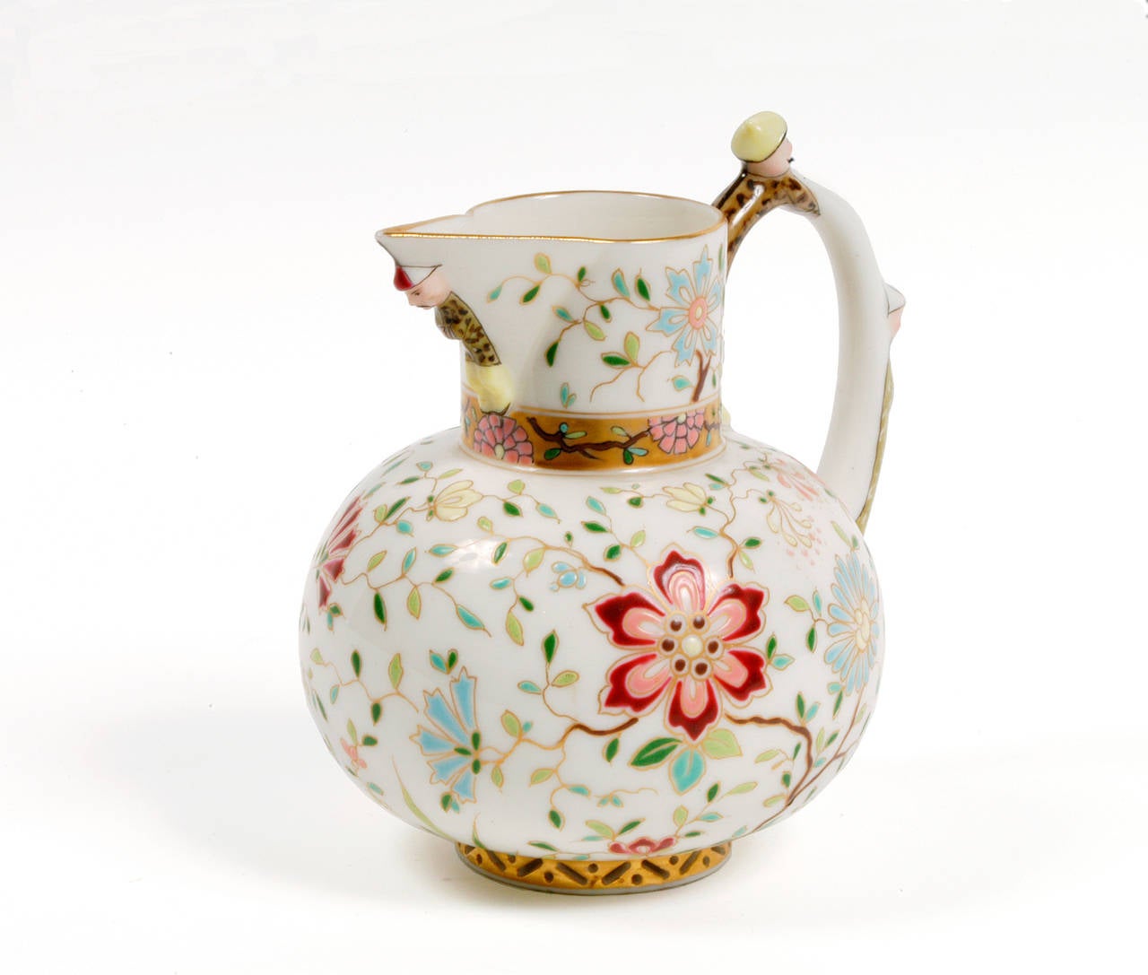 The form of this pitcher is novel and amusing, with a robed tea master poised on its handle and a beak-like spout. The all-over raised floral decoration is colorful and complements the shape of this finely cast hard paste pitcher.