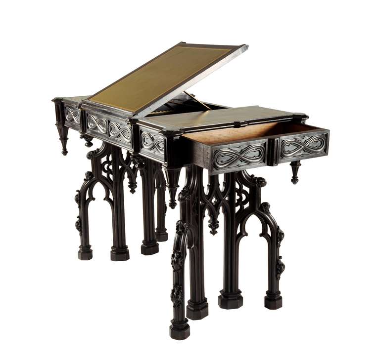 Of extraordinary quality, this highly architectural writing table is part of an identifiable suite that has been attributed to Alexander Roux (1813-1886). Roux was a French-born and- trained ébéniste who emigrated to America and opened a shop in New