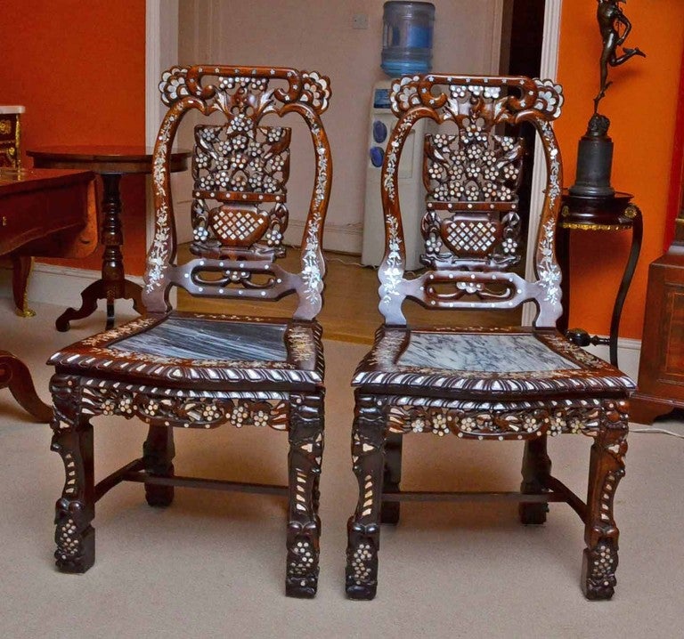 This beautiful antique pair of Chinese hardwood chairs are in excellent condition and are Circa 1900 in date. They feature wonderful profuse inlaid mother of pearl decoration with marble inserts in the seats and are made of solid rosewood.

They are