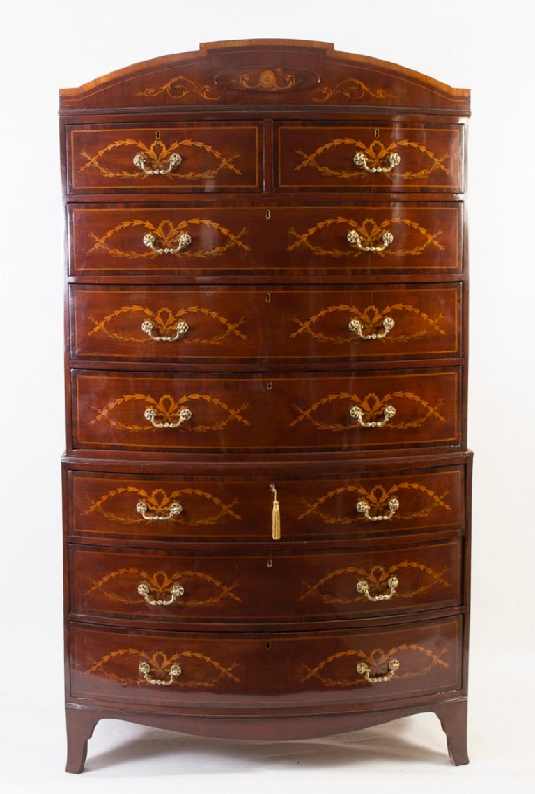 This is a beautiful antique George III mahogany chest on chest circa 1790 in date. 

It is of bow fronted form and is beautifully decorated with symmetrical swag marquetry. The drawers are elegantly crossbanded in rosewood. 

The upper section
