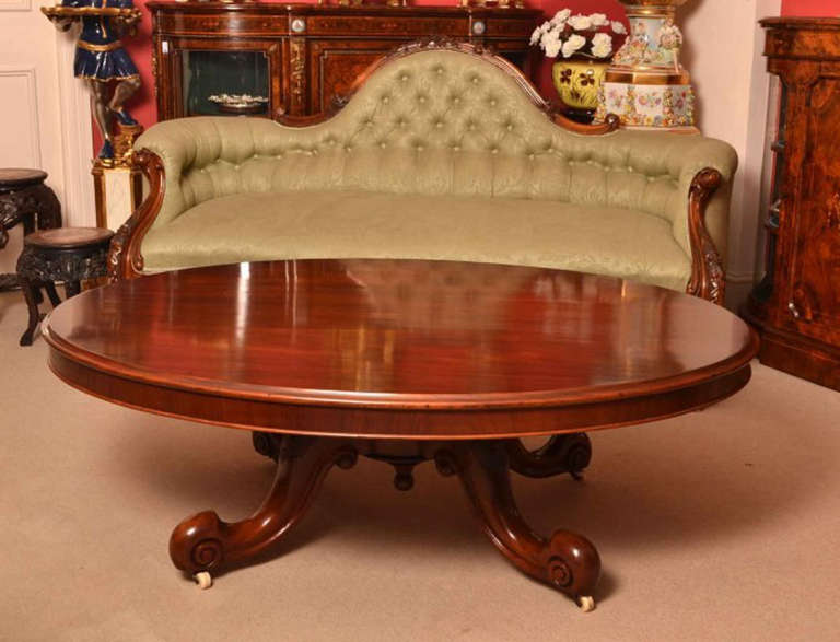 This is a charming antique Victorian mahogany coffee table with hand carved solid mahogany base, circa 1870 in date. 

The table top is oval in shape and of fabulous quality mahogany, which is typical of the Victorian period. 

The base has been