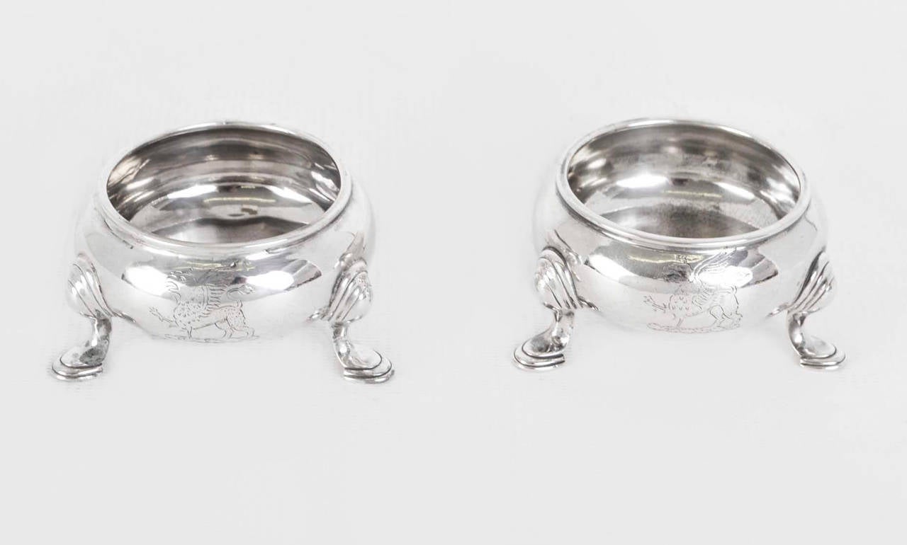 This is an exquisite antique pair of George II English sterling silver salts bearing hallmarks for London 1734 and the makers mark of the renowned silversmith Paul de Lamerie. 

The Victoria and Albert Museum describes him as 