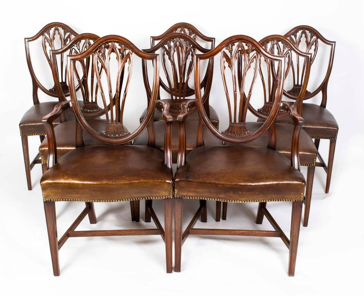 This is a fantastic antique English-made set of eight Hepplewhite style dining chairs circa 1900 in date. 

These chairs have been masterfully crafted in beautiful solid mahogany throughout and the finish and attention to detail on display are