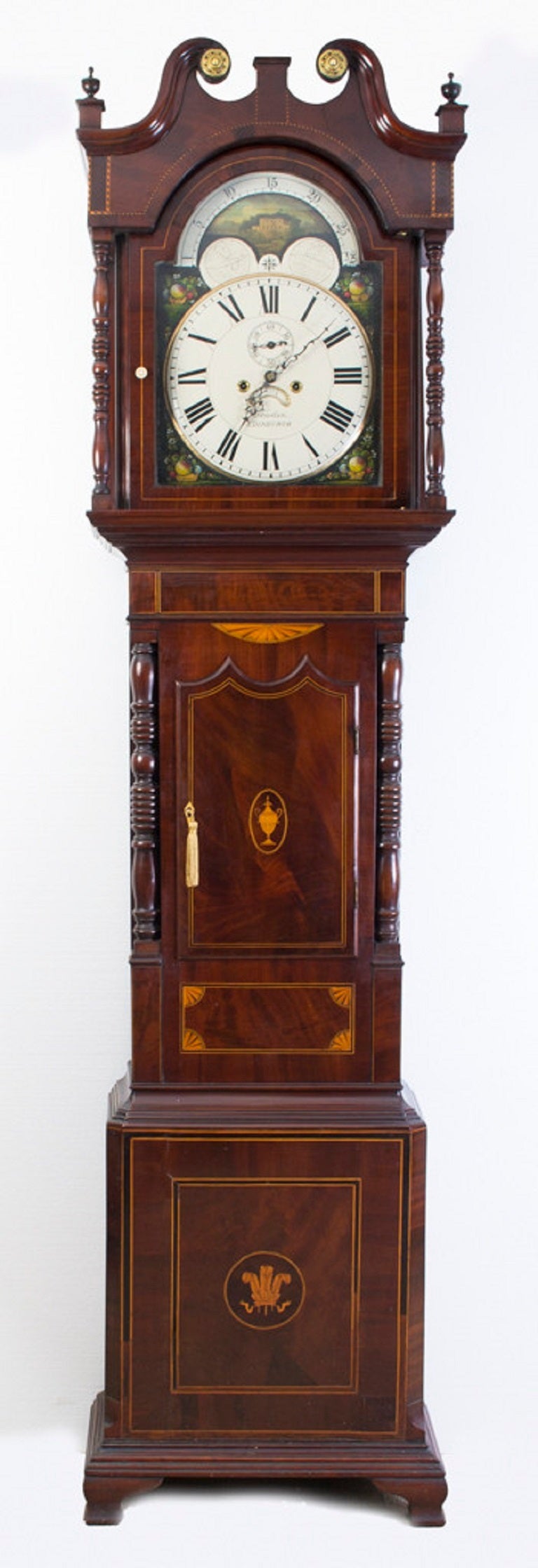 This is a beautiful early 19th century inlaid flame mahogany long case clock with a 36 cm white arched dial signed by a maker of repute, J Howden, Edinburgh. 

It has a subsidiary seconds and a date aperture, the corner spandrels of the dial are