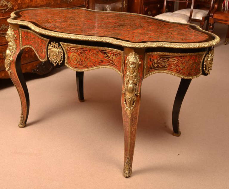 This is an absolutely stunning, antique, French tortoiseshell and cut brass 'boulle', ebonised centre table with fabulous ormolu mounts, c.1870 in date.

The table is beautifully inlaid in cut brass on tortoiseshell with winged cherubs, a cupid