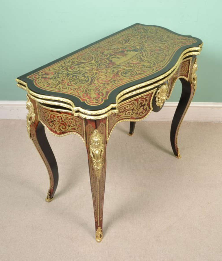 This is an absolutely stunning, antique, French red tortoiseshell and cut brass 'boulle', ebonised centre table with fabulous ormolu mounts, c.1860 in date.

The table is beautifully inlaid in cut brass on tortoiseshell with a plethora of