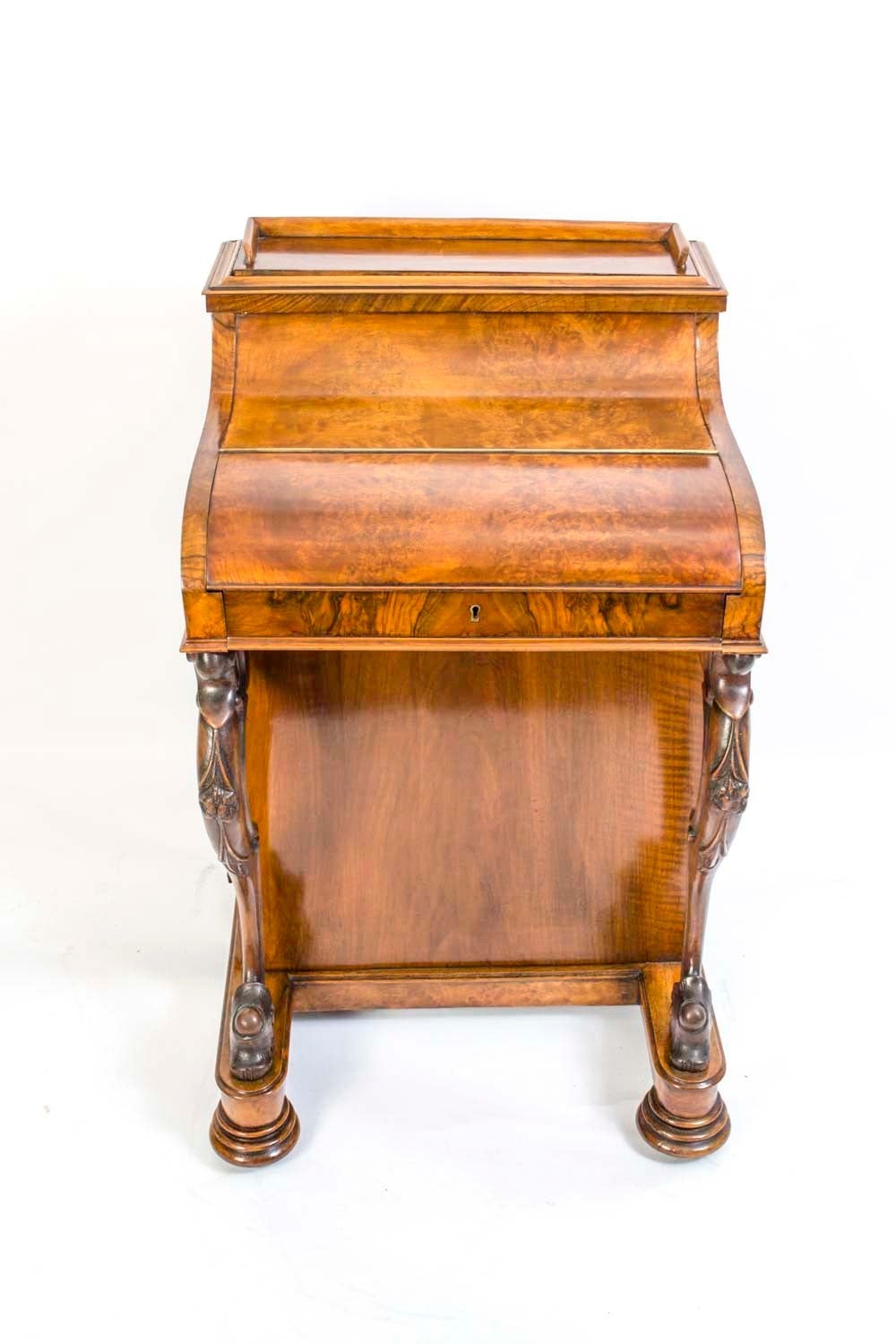 This gorgeous antique Davenport desk c.1860 is crafted from beautiful burr walnut and features the beautiful original tooled and gilded leather inset, an elegant pair of solid walnut and hand carved cabriole legs, and a secret compartment that pops