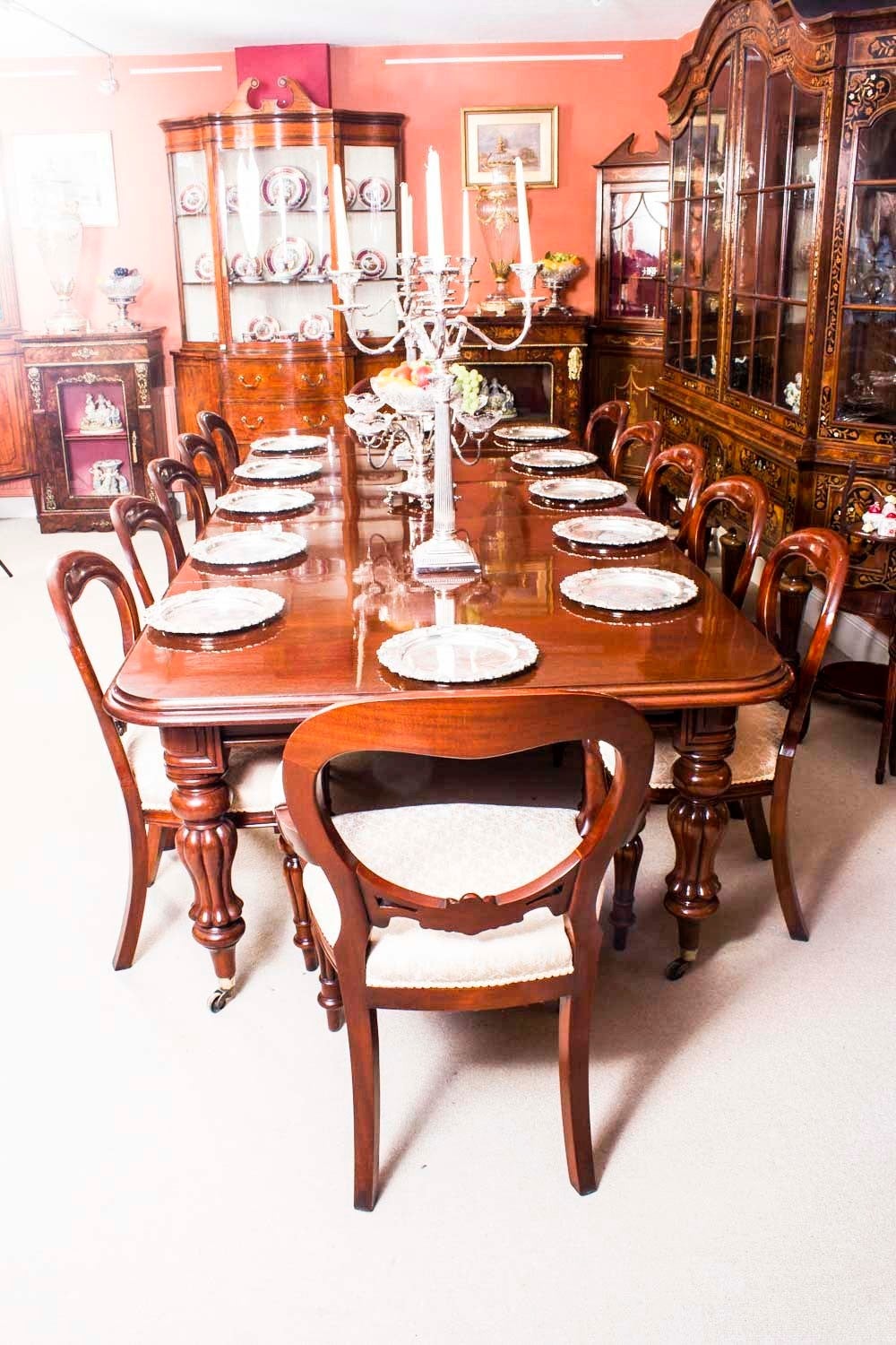 This is a fabulous exquisite English antique early Victorian solid mahogany extending dining table, circa 1840 in date and set of twelve vintage mahogany balloon back dining chairs. 

This amazing table has three original leaves and can
