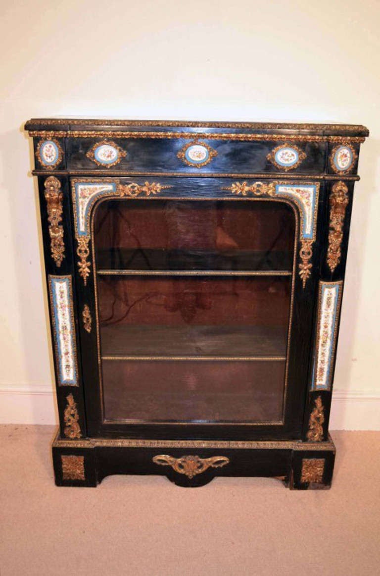 This Antique Victorian ebonised pier cabinet with Sevres plaques, circa 1850 is a true rarity.

Adding to its truly unique character, it is decorated with exquisite gilded ormolu mounts and is further embellished by the addition of hand- painted