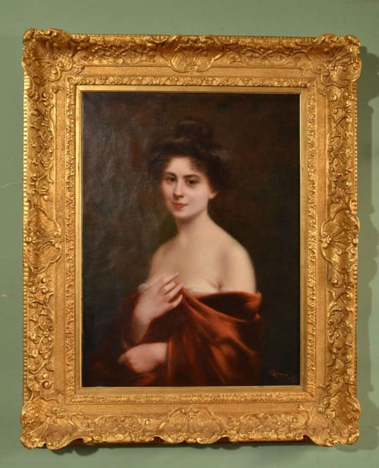 This is an antique oil on canvas, portrait of a lady painted and signed by Spanish artist Eduardo Zamocois y Zabala c.1868

It depicts beautiful and demure lady with bare shoulders, wrapped in a soft, red velvety gown.

The painting is