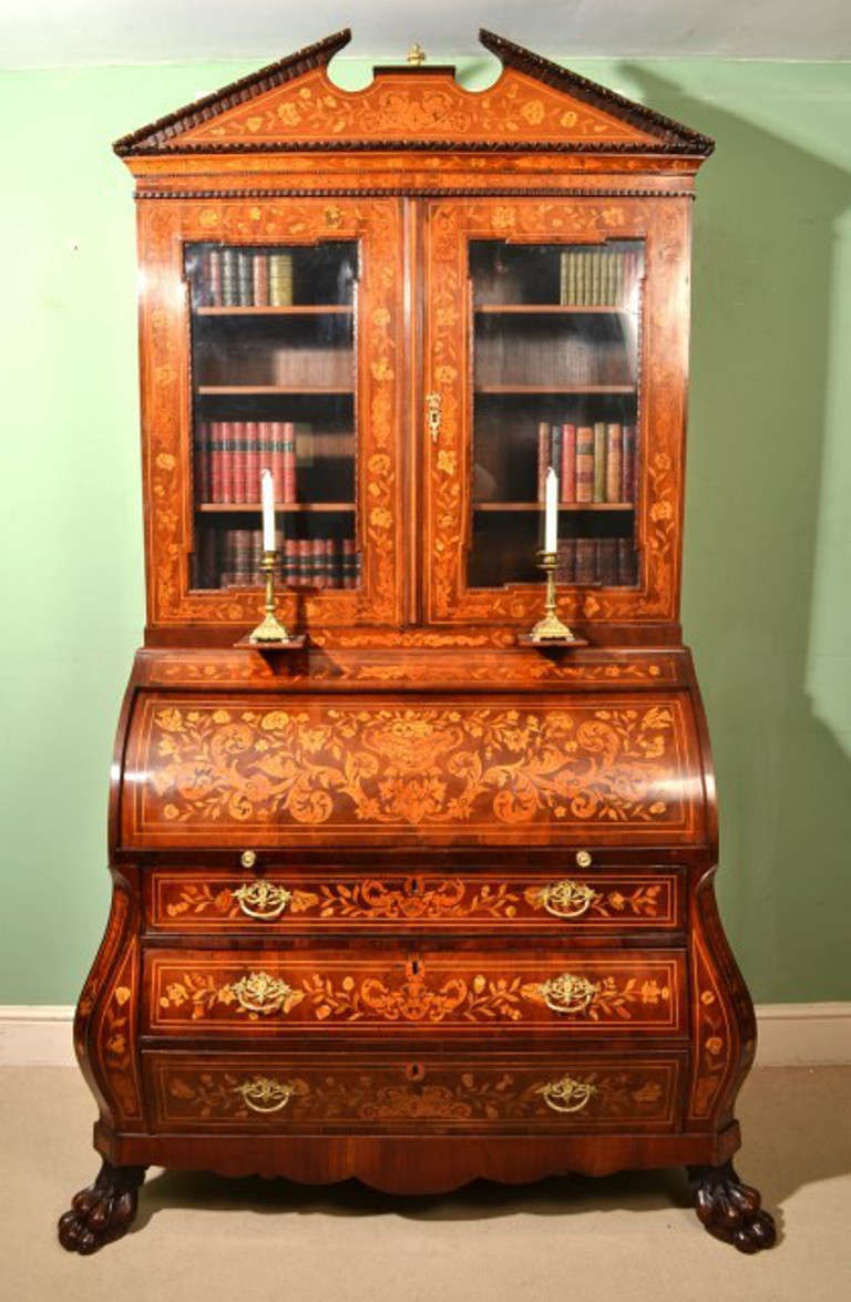 This is a beautiful antique Dutch marquetry cylinder bureau bookcase, circa 1800 in date.

It has been made from the finest mahogany with fabulous floral marquetry decoration of various exotic veneers, and elegant ormolu handles and mounts.

The