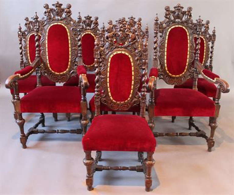 This is a beautiful and rare set of eight antique Victorian Carolean style dining chairs comprising six side chairs and two armchairs, circa 1860 in date.

These chairs are made of solid oak and have beautiful burgundy velvet upholstery. They have