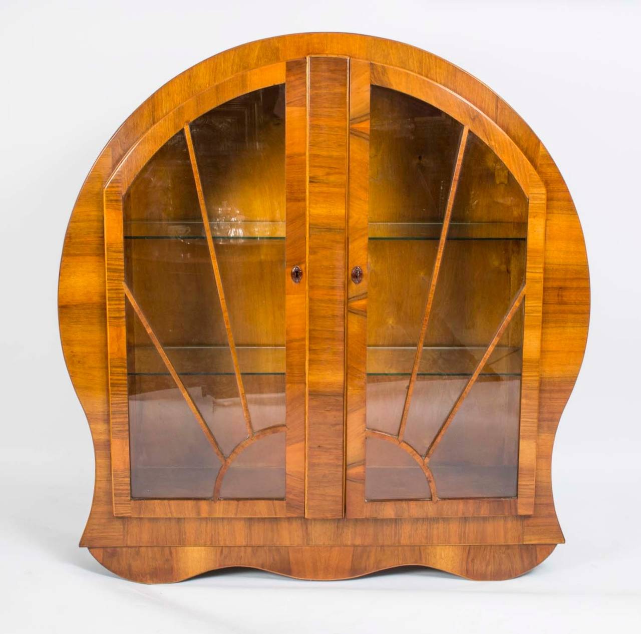 This is a lovely, antique Art Deco burr walnut display cabinet with sunrise glazed door, circa 1920 in date. 

The astragal glass door enclose two glass shelves and features original handles, working lock and key. 

The cabinet can be used to