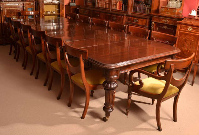 There is no mistaking the style and sophisticated design of this exquisite dining set comprising an antique Victorian dining table, circa 1860 in date and set of fourteen Vintage bar back dining chairs.

This amazing table has four leaves which