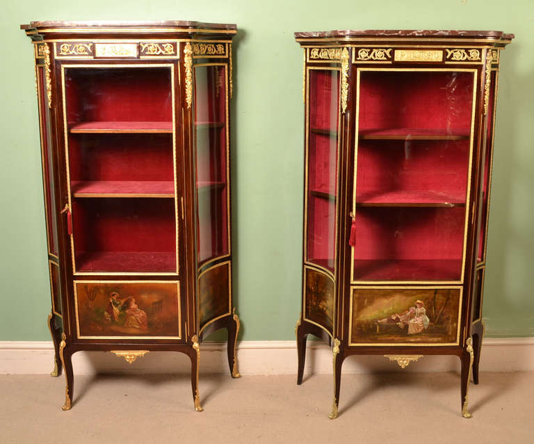 This is a stunning near pair of antique French Vernis Martin display cabinets in the Louis XV manner, circa 1880 in date.

These beautiful cabinets have hand painted decoration, exquisite ormolu mounts and Rouge Griotte marble tops. The central