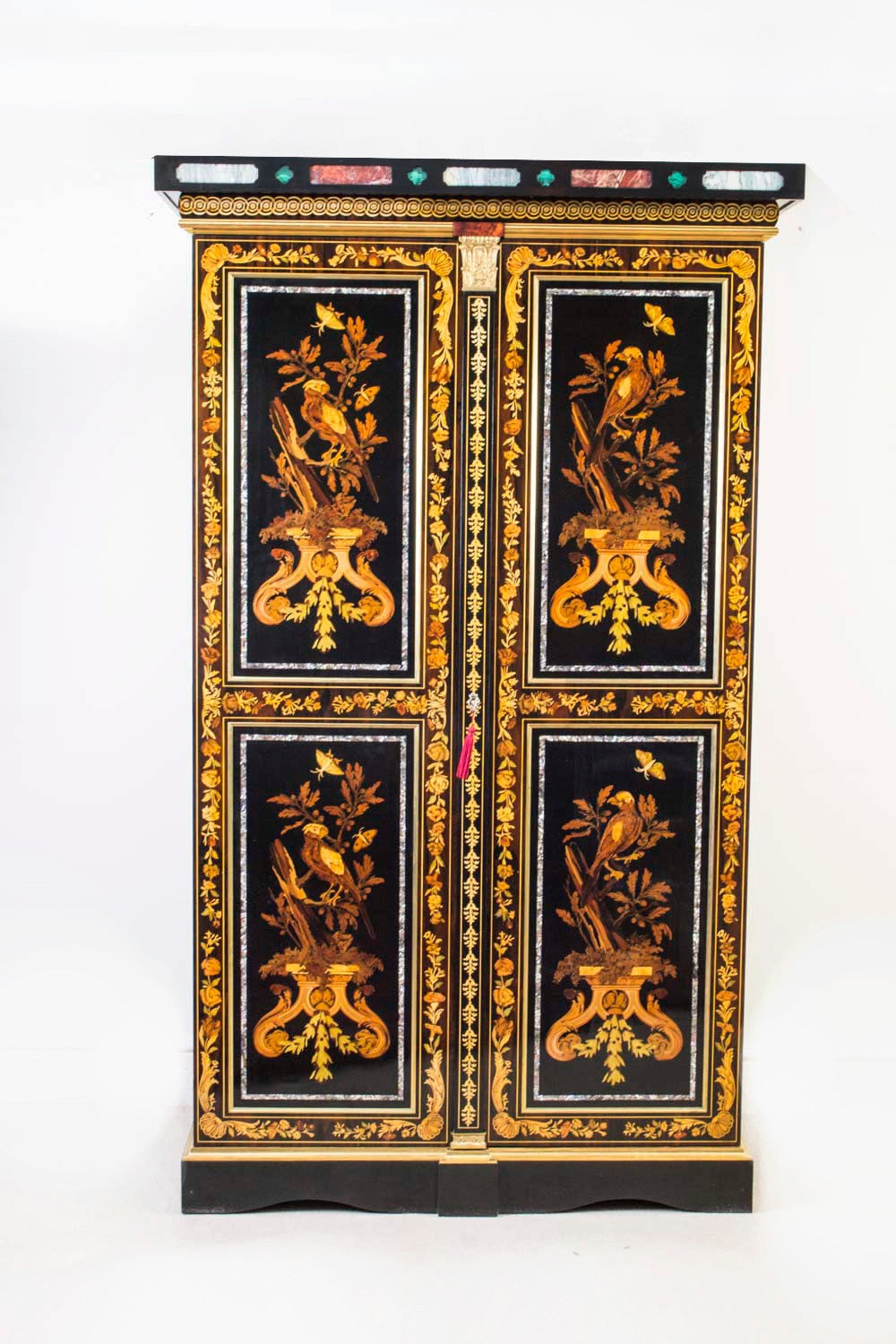 This is an absolutely exquisite pair of antique French ebonised and marquetry cabinets, dating from the early 20th century. 

The cabinets have been accomplished in a variety of exotic woods such as: rosewood, tulipwood, kingwood, coromandel, burr