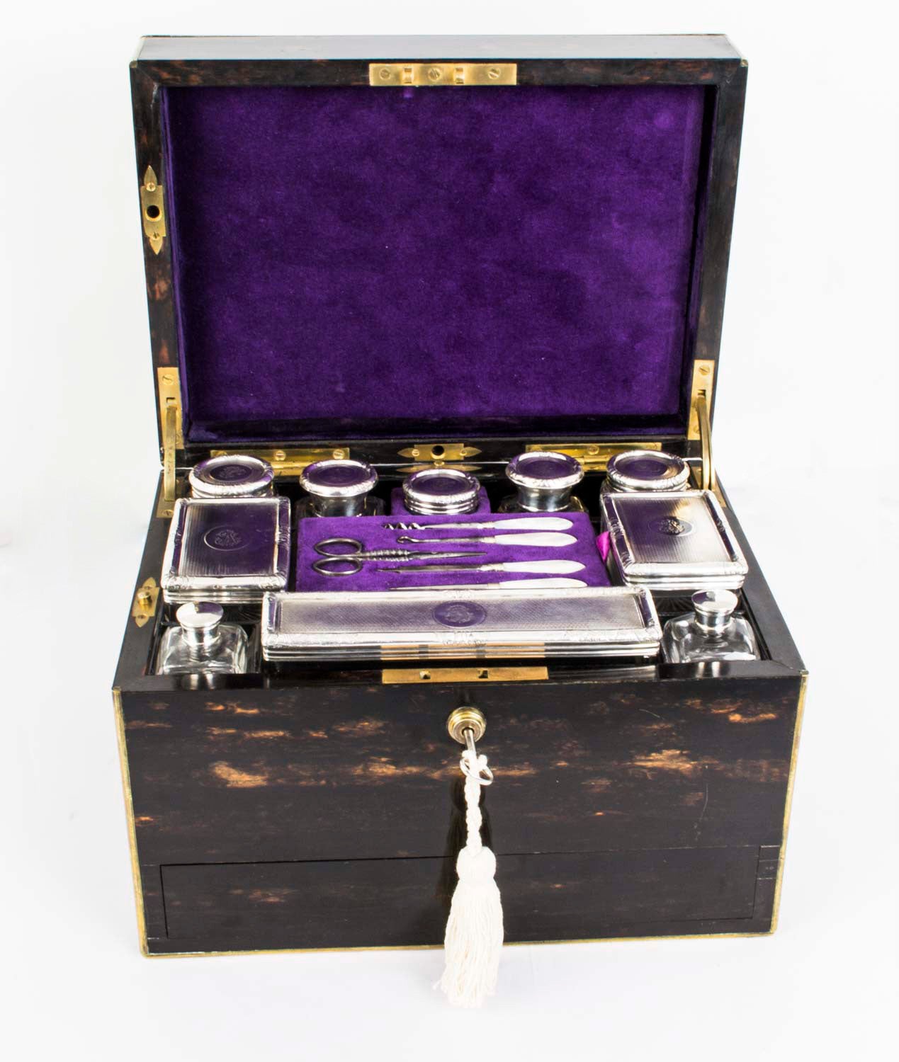 This is a stunning antique Victorian lady's traveling case, the sterling silver topped jars and bottles have hallmarks for London 1878 and the makers mark of the renowned silversmith and box maker George Betjemann & Sons. 

The case has the mark