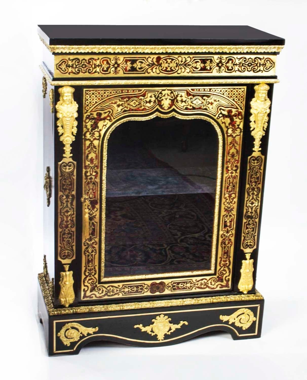 This is a stunning antique Napoleon III tortoiseshell and cut brass Boulle pier cabinet, circa 1860 in date. 

This cabinet is ebonised and decorated with exquisite ormolu mounts. It has a glazed door which is flanked with pristine ormolu