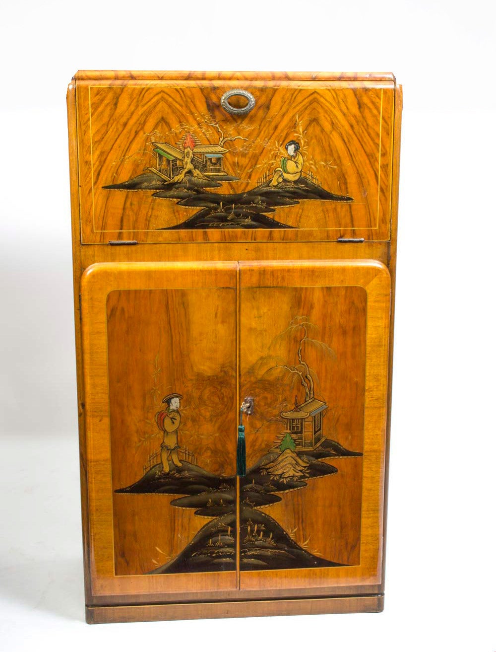 This is a fantastic antique Art Deco walnut cocktail cabinet with Chinoiserie lacquered decoration, circa 1920 in date. 

There is a paper label on the back with the details of the original owner and a the name of the manufacturer as 'Rivington