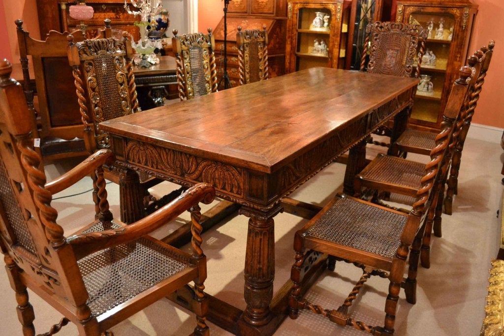 There is no mistaking the style and design of this exquisite antique English refectory table, in the Jacobean style, Circa 1880 in date and the set of eight Charles II style Carolean dining chairs, comprising six chairs and two armchairs, from the