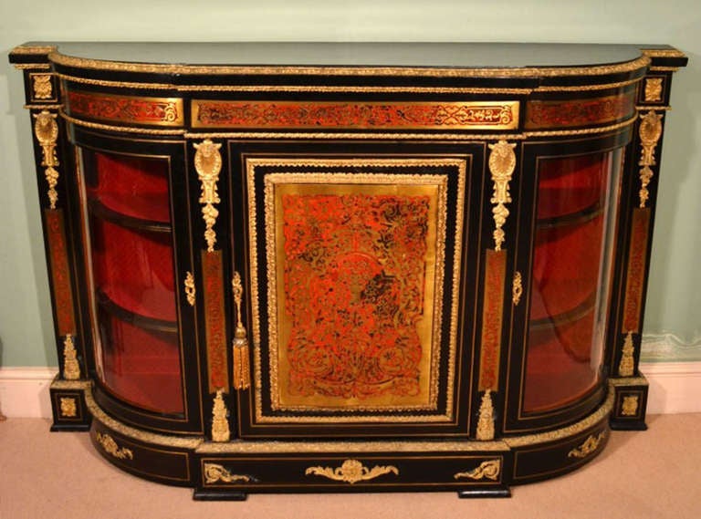 This is a stunning antique Victorian ebonised walnut, gilt ormolu mounted, and red tortoiseshell boulle marquetry credenza, from the last quarter of the 19th Century. 

It is beautifully inlaid with scrolling foliage, flowers and honeysuckle. The