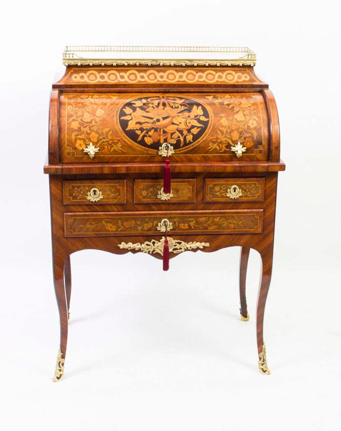 This is a gorgeous antique French kingwood and marquetry Louis XV Revival secretaire a cylindre, circa 1870 in date. 

It is decorated throughout with beautiful floral marquetry and has a stunning marquetry panel of musical instruments, finished