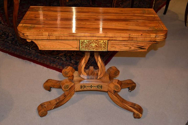 This is a very attractive antique English Regency Coromandel and cut brass inlaid card table, circa 1820 in date. 

This rectangular card table is made from the exotic and rare Coromandel, otherwise known as Calamander, wood, it has fabulous