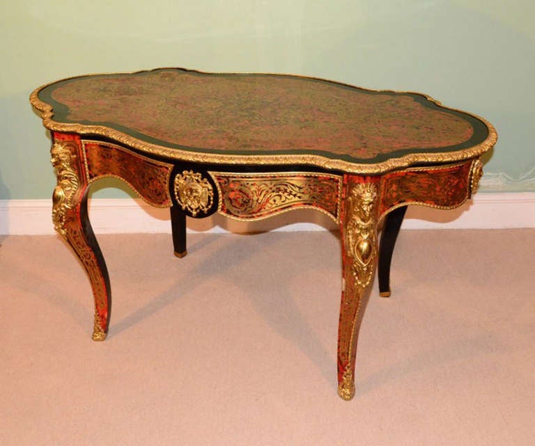 This is an absolutely stunning, antique, French tortoiseshell and cut brass 'boulle', ebonised centre table with fabulous ormolu mounts, c.1870 in date. 

The table is beautifully inlaid in cut brass on tortoiseshell with three winged cherubs, a