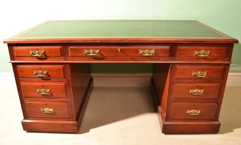 This is an antique Victorian solid walnut pedestal desk, by Maple & Co. Ltd, circa 1880 in date.

The desk has fabulous a gold tooled green leather inset writing surface, nine capacious drawers, original locks and handles, and the makers name