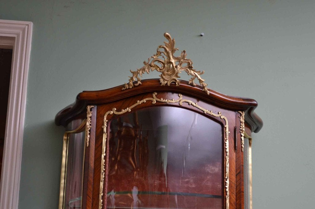 A stunning antique French Vernis Marten display cabinet in the Louis XV manner, Circa 1880 in date, with exquisite hand painted decoration and exquisite ormolu mounts. The centre panel has a beautiful painting depicting a courting couple and the two