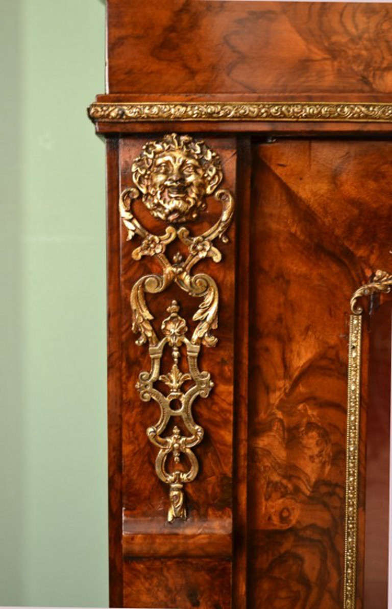 This stunning antique Victorian pier cabinet is a true rarity. It has been accomplished in burr walnut with a glazed door, the whole beautifully inlaid. It dates from circa 1870.

Adding to its truly unique character, it is decorated with