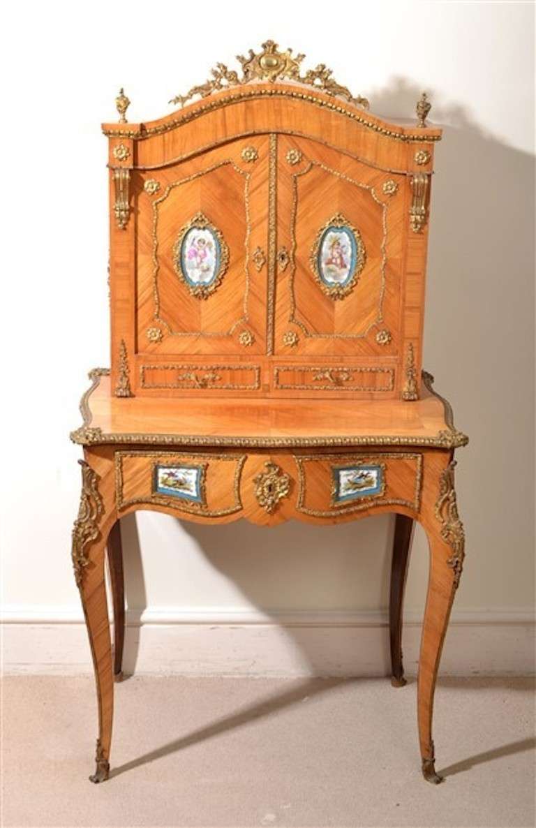 This is a gorgeous Louis XV style, kingwood Bonheur Du Jour, or Ladies writing desk, with Sevres porcelain plaques, circa 1880 in date. The superstructure comprises a pair of cupboard doors which open to reveal a beautifully finished rosewood