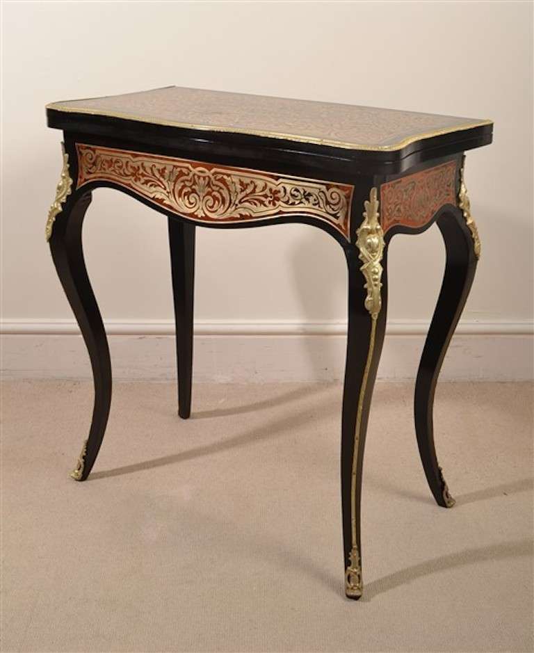 This is an absolutely stunning, antique, French red tortoiseshell and cut brass boulle, ebonized card table with fabulous ormolu mounts, circa 1860 in date. The table is beautifully inlaid in cut brass on tortoiseshell with a plethora of exquisite