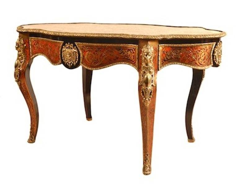 This is an absolutely stunning antique French red tortoiseshell and cut brass 'boulle' ebonized writing table with fabulous gilded ormolu mounts, circa 1870 in date. 

The desk is beautifully inlaid in cut brass on red tortoiseshell with winged