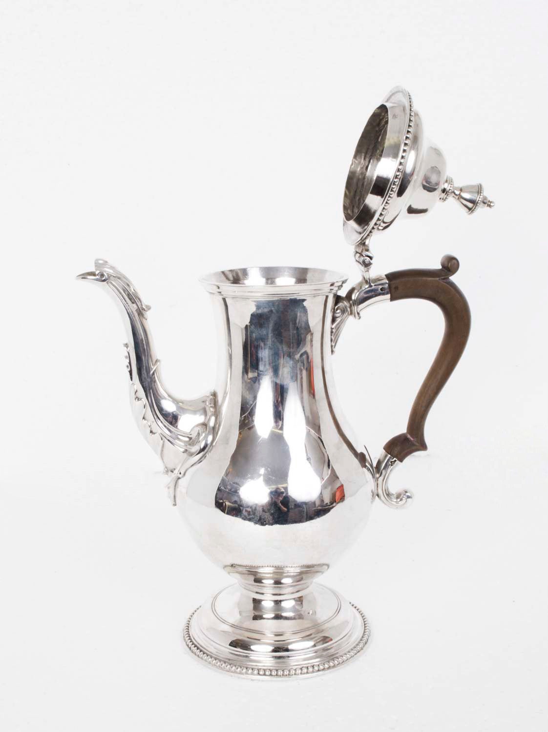 This is a wonderful antique sterling silver coffee pot by the celebrated silversmith Hester Bateman. 

It bears hallmarks for London 1775 and the makers mark of the world renowned silversmith Hester Bateman. 

It is beautifully made in sterling