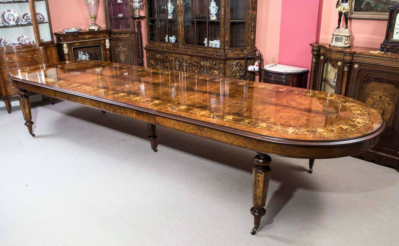 This is a stunning Vintage Victorian style extending burr walnut and marquetry dining table with matching set of fourteen chairs. 

This table is made from burr walnut which has a beautiful grain, and this has been embellished with superb inlaid