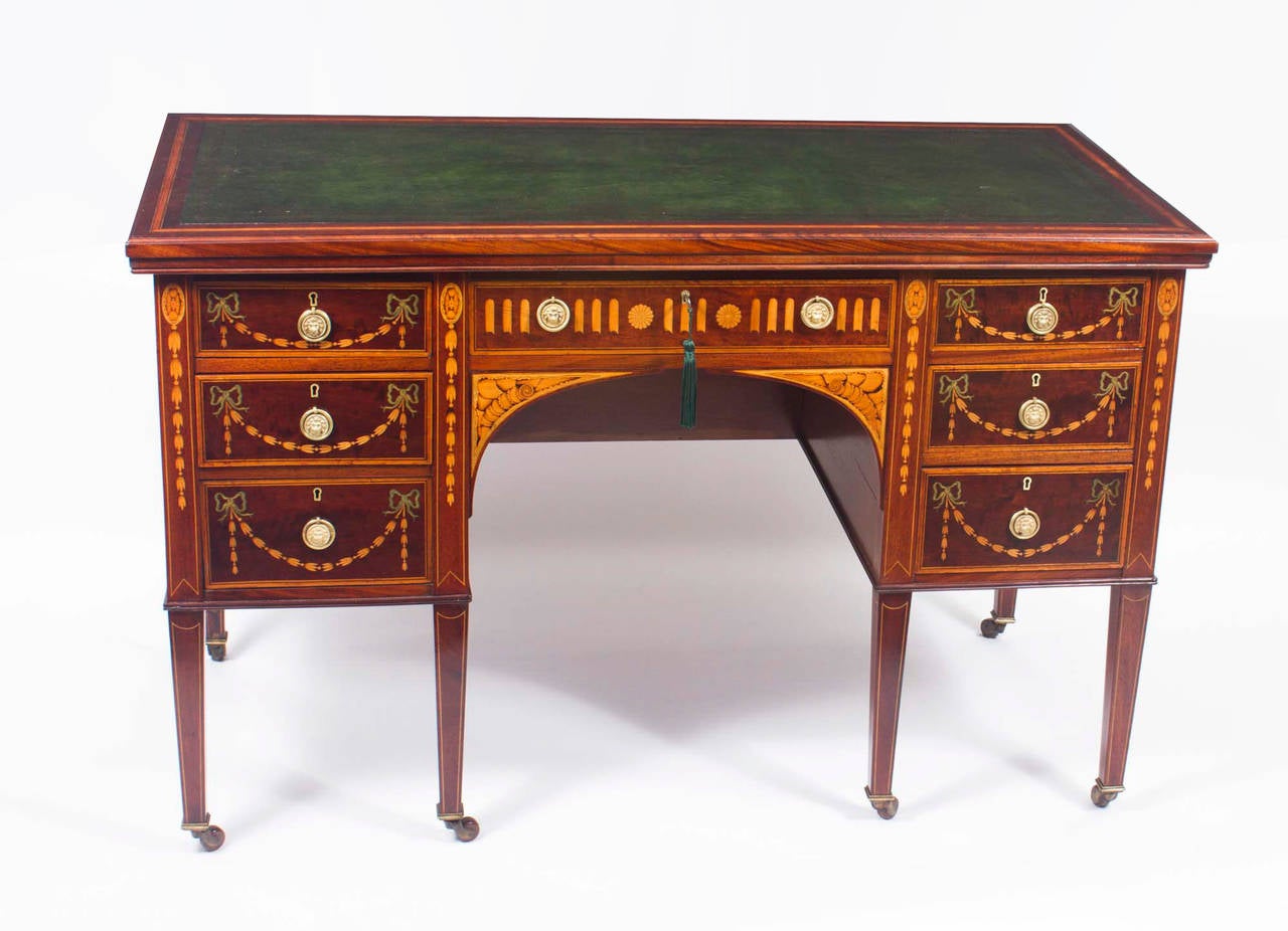 This is a stunning antique Edwardian writing desk, circa 1900 in date and in the manner of Edwards & Roberts. 

It has a fabulous green leather writing surface with hand tooled gold leaf decoration. It is made of solid mahogany and crossbanded