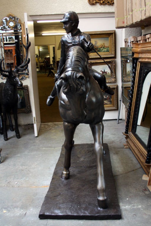 A truly stunning life size bronze statue of a horse and his jockey.

The quality of the bronze is second to none and the attention to detail throughout is utterly fantastic.

The sculpture shows an elegant horse on parade with his jockey on his