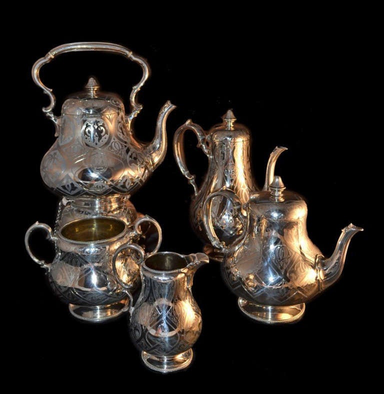 This is an exquisite five piece antique set with hallmarks for London 1865 and the makers mark of the renowned silversmiths Robert Hennell III. 

The set comprises a sterling silver four piece tea and coffee set and the original matching silver