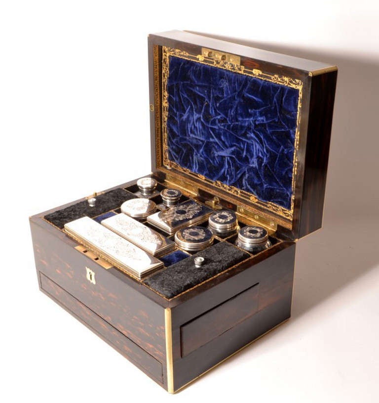 This is a stunning antique Victorian lady's traveling case, the sterling silver topped jars and bottles have hallmarks for London 1852 and the makers mark of the renowned silversmith Thomas Johnson Ist. 

This traveling case is made of coromandel